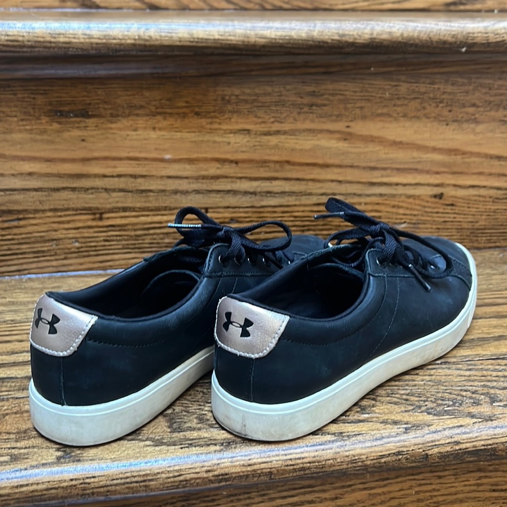 Under Armour black street sneaker with gold touch on the back. Size 7